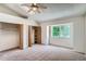 Carpeted bedroom with vaulted ceiling, ceiling fan, and closet at 7476 E Arkansas Ave # 35-10, Denver, CO 80231