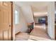 Inviting entryway featuring wood floors, staircase, and abundant natural light from a nearby window at 7476 E Arkansas Ave # 35-10, Denver, CO 80231