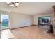 Bright living room featuring hardwood floors, a brick fireplace, and a sliding door to the outdoor space at 7476 E Arkansas Ave # 35-10, Denver, CO 80231