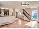 Open-concept living room with hardwood floors and staircase at 7476 E Arkansas Ave # 35-10, Denver, CO 80231