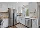 Clean kitchen featuring stainless steel appliances, sleek countertops, and ample lighting at 19820 E Amherst Dr, Aurora, CO 80013