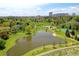 Aerial view of the community pond, green spaces, and surrounding neighborhood offering a picturesque setting at 6054 S Akron Way, Greenwood Village, CO 80111