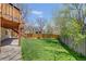 Expansive backyard featuring lush lawn, privacy fence, and a wooden deck, perfect for outdoor living and entertaining at 6054 S Akron Way, Greenwood Village, CO 80111