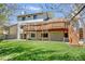 Expansive backyard featuring a spacious deck, lush lawn, and a walk-out basement at 6054 S Akron Way, Greenwood Village, CO 80111
