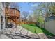 Spacious backyard with a well-maintained lawn, a deck, and ample space for outdoor activities and relaxation at 6054 S Akron Way, Greenwood Village, CO 80111