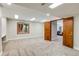 Spacious basement features large open room with lots of lights and 2 full size doors at 6054 S Akron Way, Greenwood Village, CO 80111