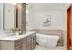 Modern bathroom with dual sinks, a freestanding tub, tile accents, and stylish fixtures at 6054 S Akron Way, Greenwood Village, CO 80111