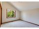 Bright bedroom with a large window, vaulted ceilings and neutral carpeting at 6054 S Akron Way, Greenwood Village, CO 80111