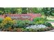 Sundance Valley brick community sign surrounded by vibrant flowers and greenery at 6054 S Akron Way, Greenwood Village, CO 80111