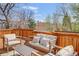 Spacious wood deck with cozy seating and views of the surrounding neighborhood and lush trees at 6054 S Akron Way, Greenwood Village, CO 80111