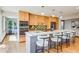 Modern kitchen features stainless steel appliances, light wood cabinets, and an island with seating at 6054 S Akron Way, Greenwood Village, CO 80111