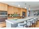 Modern kitchen featuring a large island with seating, stainless steel appliances, and sleek countertops at 6054 S Akron Way, Greenwood Village, CO 80111