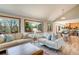 Inviting living room featuring large windows, plush sofas, and an open layout, creating a comfortable space at 6054 S Akron Way, Greenwood Village, CO 80111