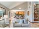 Bright living room with hardwood floors, soaring ceilings, and an open floor plan leading to the kitchen at 6054 S Akron Way, Greenwood Village, CO 80111