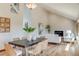Open-concept dining area with natural light, seamlessly flowing into the living room with a cozy fireplace at 6054 S Akron Way, Greenwood Village, CO 80111