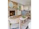 Inviting living room featuring a brick fireplace, wet bar, and comfortable seating arrangement at 6054 S Akron Way, Greenwood Village, CO 80111