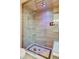 Luxurious walk-in shower with a glass enclosure, rain shower head, and modern tile design at 6054 S Akron Way, Greenwood Village, CO 80111