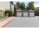 Three car garage with beige doors, and grey trim at 850 W Moorhead Cir # 3L, Boulder, CO 80305