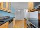 Bright kitchen with stainless steel appliances, stone countertops, and cork floors at 850 W Moorhead Cir # 3L, Boulder, CO 80305