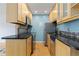 Galley kitchen featuring stainless appliances, black counters, and wooden cabinets at 850 W Moorhead Cir # 3L, Boulder, CO 80305