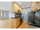 Well-lit kitchen features stainless steel appliances, wooden cabinets, and an adjacent dining area at 850 W Moorhead Cir # 3L, Boulder, CO 80305