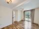 Open bedroom featuring light wood flooring, ceiling fan, and sliding glass door at 6047 S Hill St, Littleton, CO 80120