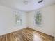 Bright bedroom featuring hardwood floors and two windows at 6047 S Hill St, Littleton, CO 80120
