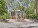 Charming home featuring a white picket fence and mature trees, offering curb appeal and privacy at 6047 S Hill St, Littleton, CO 80120