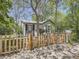 Charming home features a decorative fence with mature trees, offering curb appeal and a cozy entrance at 6047 S Hill St, Littleton, CO 80120