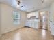 Cozy kitchen featuring bright white cabinets, a ceiling fan and natural light from an adjacent window at 6047 S Hill St, Littleton, CO 80120