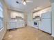 Classic white kitchen features ample cabinetry, standard appliances, and bright overhead lighting at 6047 S Hill St, Littleton, CO 80120