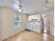 Bright kitchen features white cabinets, appliances, tile backsplash, and light wood floors at 6047 S Hill St, Littleton, CO 80120