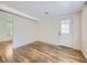 Bright, open room with wood floors and a view of the door and window at 6047 S Hill St, Littleton, CO 80120