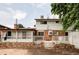 Back of the house featuring brick accents, a deck, fenced-in yard, and mature landscaping at 9290 Quitman St, Westminster, CO 80031