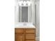 Bathroom sink and vanity combination with light wood cabinets, chrome faucet, and a large mirror at 9290 Quitman St, Westminster, CO 80031