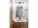 Bathroom featuring a vanity with wood cabinets, light-colored sink, and modern lighting fixtures at 9290 Quitman St, Westminster, CO 80031
