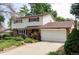 Charming two-story home with a brick and white facade, large garage, and manicured lawn at 9290 Quitman St, Westminster, CO 80031
