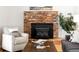 Living room fireplace with brick surround and decorative Timberline wood-burning stove insert at 9290 Quitman St, Westminster, CO 80031