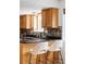 Stylish kitchen featuring granite counters, wood cabinets, and bar stool seating at 9290 Quitman St, Westminster, CO 80031
