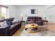 Comfortable living room with leather seating, wood floors, and stylish decor at 9290 Quitman St, Westminster, CO 80031