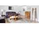 Open living room with leather sofas, wood floors, and a view to the dining area at 9290 Quitman St, Westminster, CO 80031