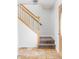 Foyer with carpeted staircase, wooden railing, and tile flooring at 9290 Quitman St, Westminster, CO 80031