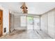 Spacious sunroom with vintage light fixtures, sliding glass doors, tile flooring, and access to the deck at 9290 Quitman St, Westminster, CO 80031