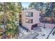 An aerial view showcasing a contemporary home with a unique architectural design and a basketball court at 13682 W Virginia Dr, Lakewood, CO 80228