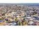 Aerial view showing a house's location in a residential area with city views in the distance at 13682 W Virginia Dr, Lakewood, CO 80228