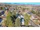 Aerial view of a house on a tree-lined street in a residential neighborhood with mountain views at 13682 W Virginia Dr, Lakewood, CO 80228