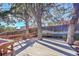 Wooden deck in backyard shaded by large trees at 13682 W Virginia Dr, Lakewood, CO 80228