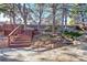 Landscaped backyard with wooden deck and stairs at 13682 W Virginia Dr, Lakewood, CO 80228