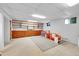 Finished basement with built-in shelving and space for play at 13682 W Virginia Dr, Lakewood, CO 80228