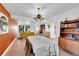 Mid-century modern dining area with a wood-paneled accent wall and chandelier at 13682 W Virginia Dr, Lakewood, CO 80228